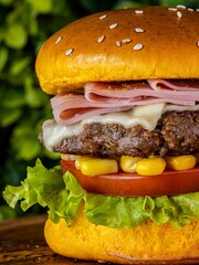 Poster - Delicious cheeseburger served with freshly-sliced tomatoes and corn on the cob, on a tabletop