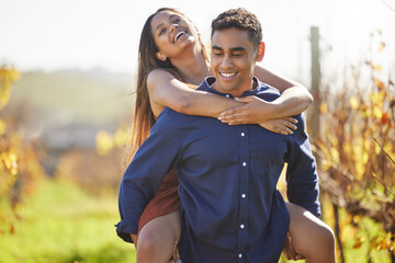 Wall Mural - Where to, my love. a handsome young man piggybacking his girlfriend on a wine farm.