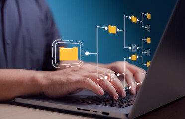 Wall Mural - Document management system concept, Storage backup online software for efficient management of company files and data. Businessman using laptop to arrange folder and files icon on virtual screen.