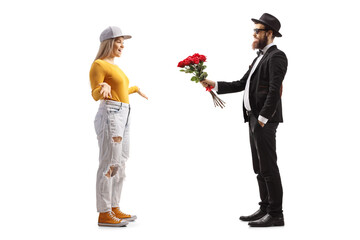 Poster - Full length profile shot of a man giving a bouquet of red roses to a young casual female