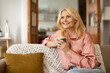 © Prostock-studio - Mature Lady Enjoying Coffee Drink Sitting On Couch At Home