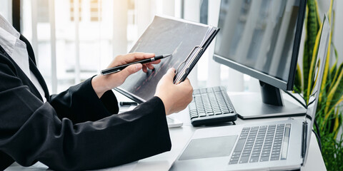 Poster - Businesswoman is pointing stock data chart to taking note on doc