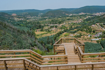 Wall Mural - Wooden walkway at viewpoint over forest and Vila Nova do Ceira, Góis PORTUGAL