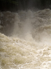 White water river rapids from fast flowing river, cascade waterfall drop with plunge pool, foam, spray and current