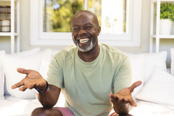 Portrait of happy senior african american man having video call