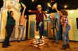 © kleberpicui - Brazilian Festa Junina. Group of friends having fun at the Festa Junina playing with the tradition of jumping over the bonfire.