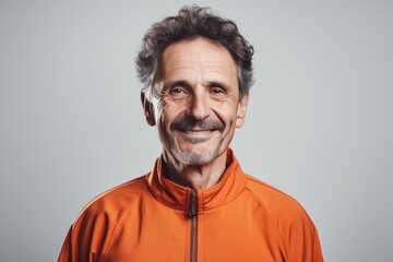 Environmental portrait photography of a pleased man in his 50s wearing a comfortable tracksuit against a white background. Generative AI