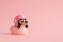 Creative Composition Made Of Pink Cute Little Rubber Duckling With A Helmet And Sunglasses On Pink Background.Summer Minimal Duck Concept. Creative Art, Contemporary Style.Writing Space, Copy Space.