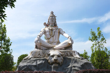 Wall Mural - God Shiva meditates sitting on a tiger skin in Rishikesh, India.