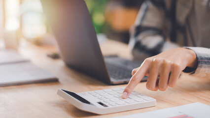 Aufkleber - Businessman using a calculator to calculate numbers ,profit and loss statement review of company performance ,cost analysis ,business account checking ,Annual budget management planning