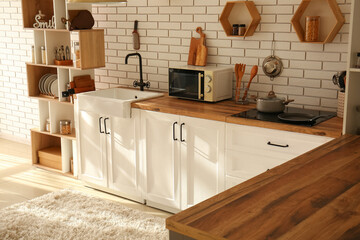 Sticker - Interior of modern kitchen with counters near white brick wall