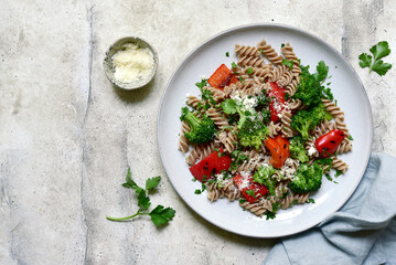 Canvas Print - Whole grain pasta fusilli with grilled bell pepper and broccoli. Top view with copy space.