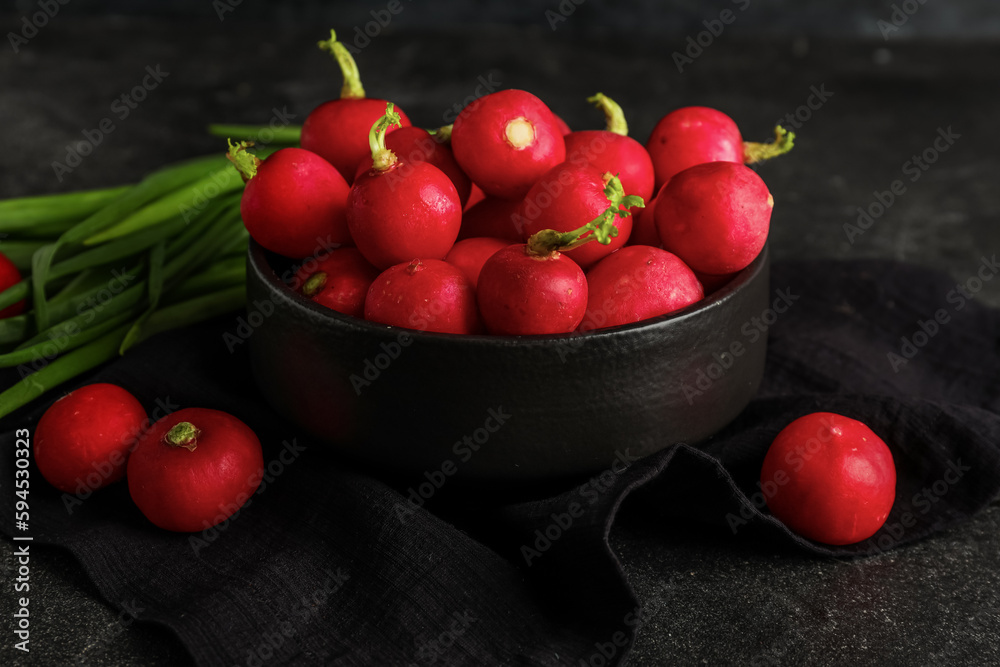 Bowl of fresh radish on dark background