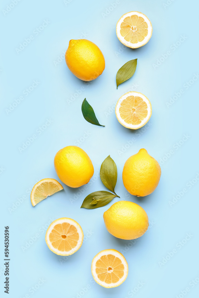 Composition with fresh lemons on blue background