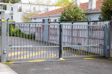 grey gate modern aluminum portal of entrance door to the building and access to the apartments with car