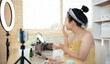 © Puwasit Inyavileart - Beautiful women with social media influences are teaching makeup and use cosmetics, In front of the camera to recording vlog video live streaming, Online business on concept of beauty bloggers.
