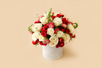 Bouquet of beautiful flowers decorated in round box on light background