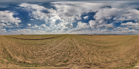 Wall Mural - spherical 360 hdri panorama among farming field with clouds on blue sky in equirectangular seamless 