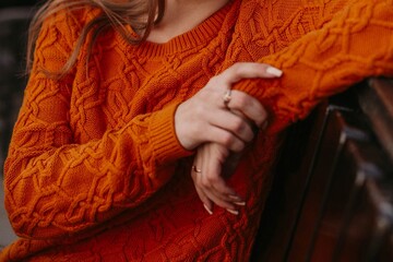 Sticker - Female figure in orange knitted cozy sweater. Autumn winter street style casual cloth concept