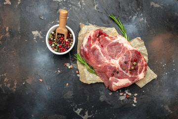 Poster - raw pork steaks on a cutting board with spices Raw meat pork steaks with seasoning. place for text, top view