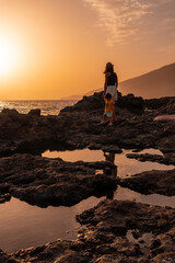 Mother and son at sunset on Tacoron beach on El Hierro, Canary Islands