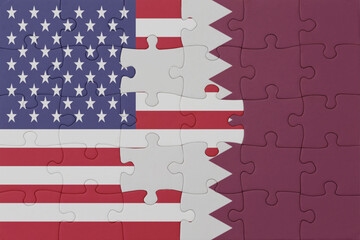 Wall Mural - puzzle with the national flag of qatar and united states of america. macro