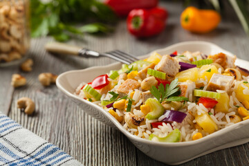 Wall Mural - Salad with rice, chicken, peanuts and vegetables. Front view.