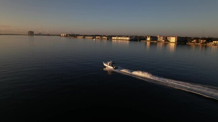 Wall Mural - Aerial of a boat sailing in the calm blue ocean at North Palm Beach, Florida on a hot sunny day