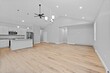 © Allan Wolf/Wirestock Creators - Room features a spacious kitchen with hardwood floors in a light gray color
