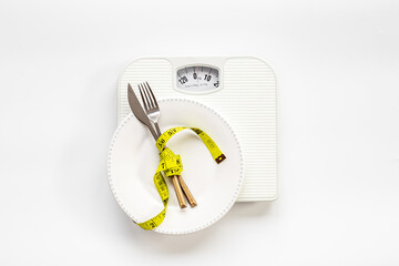 Wall Mural - Tape measure with dinner cutlery and weight scales. Dieting and weight control concept