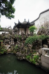 Sticker - an asian garden with a small river surrounded by rocks and trees