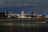 Fototapeta  - Brooklyn Bridge illuminated with lights at night on the background of the modern cityscape