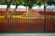 Restriction plastic mesh fence at industrial construction site. Protective barrier for pedestrians safety