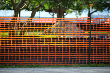 restriction plastic mesh fence at industrial construction site. protective barrier for pedestrians s