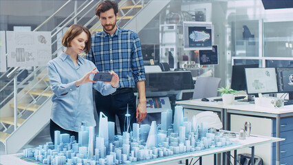 Wall Mural - architect and engineer have discussion, use augmented reality smartphone to design sustainable 3d me