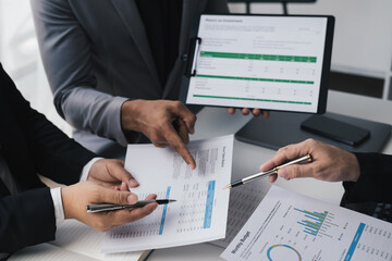 Wall Mural - Cropped shot of business people having a discussion about the investment plan together while using graph and document for the project.