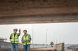 © เลิศลักษณ์ ทิพชัย - Asian male highway engineering working with architects talking and blank sheet good teamwork Engineer working on motorway bridge and concrete road at construction site