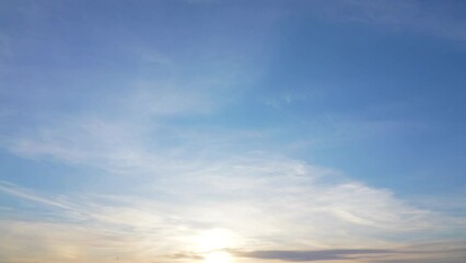 Wall Mural - 4k video panorama of beautiful peaceful sunny sunset sky. clear blue heaven with soft white and oran