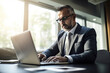 © LAYHONG - Serious mature businessman working on laptop while sitting at desk in office, Generative AI