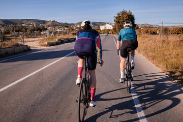 Cycling adventure in Spain.Two cyclists training on the road on road bikes.Spanish mountain biking.Training for competition.Practicing cycling on open country road.Spain