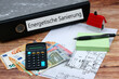 canvas print picture - Euro Geldscheine undTaschenrechner mit dem Text Fördermittel energetische Sanierung auf einem Aktenordner.