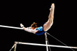 female gymnast exercise on uneven bars in artistic gymnastics, flight element from low bar to high bar, black background