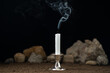 fireless candle with rocks around on dark background death sci fi
