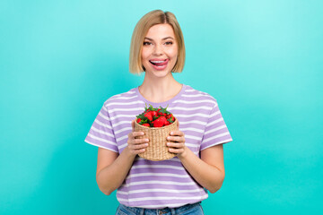 Sticker - Photo of satisfied woman bob hairdo dressed striped t-shirt hold basket of strawberries tongue lick lips isolated on teal color background