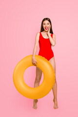 Poster - Vertical photo portrait of fit slim with matte colorful lipstick fit slim shouting beautiful lady standing on tiptoes holding big transparent lifebuyo in hand isolated bright vivid background