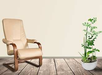 Poster - Soft armchair in the room and green houseplant near