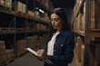 © Masson - female warehouse delivery worker with notebook, dramatic light, created with Generative AI Technology