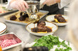 © Vanessa - Chef Plating Sous Vide Boneless Braised Short Rib Dish in Commercial Kitchen
