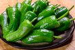 Fresh green mild padron pepper pementos, ready for grill or to be fried with olive oil, traditional snack in Galicia, Spain