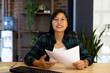 Portrait of happy asian casual businesswoman making video call smiling and holding document